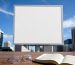 An empty white billboard and a law book, representing the tobacco advertising ban in Australia.